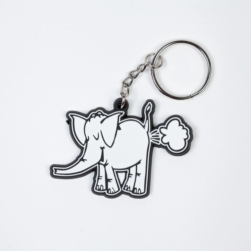 A rubber keychain shaped like an elephant, outlined in black and white.