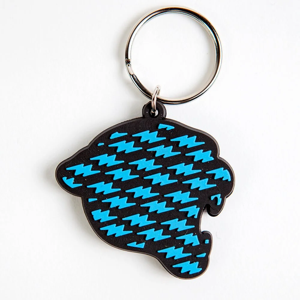 A rubber keychain with a blue zigzag pattern on black.