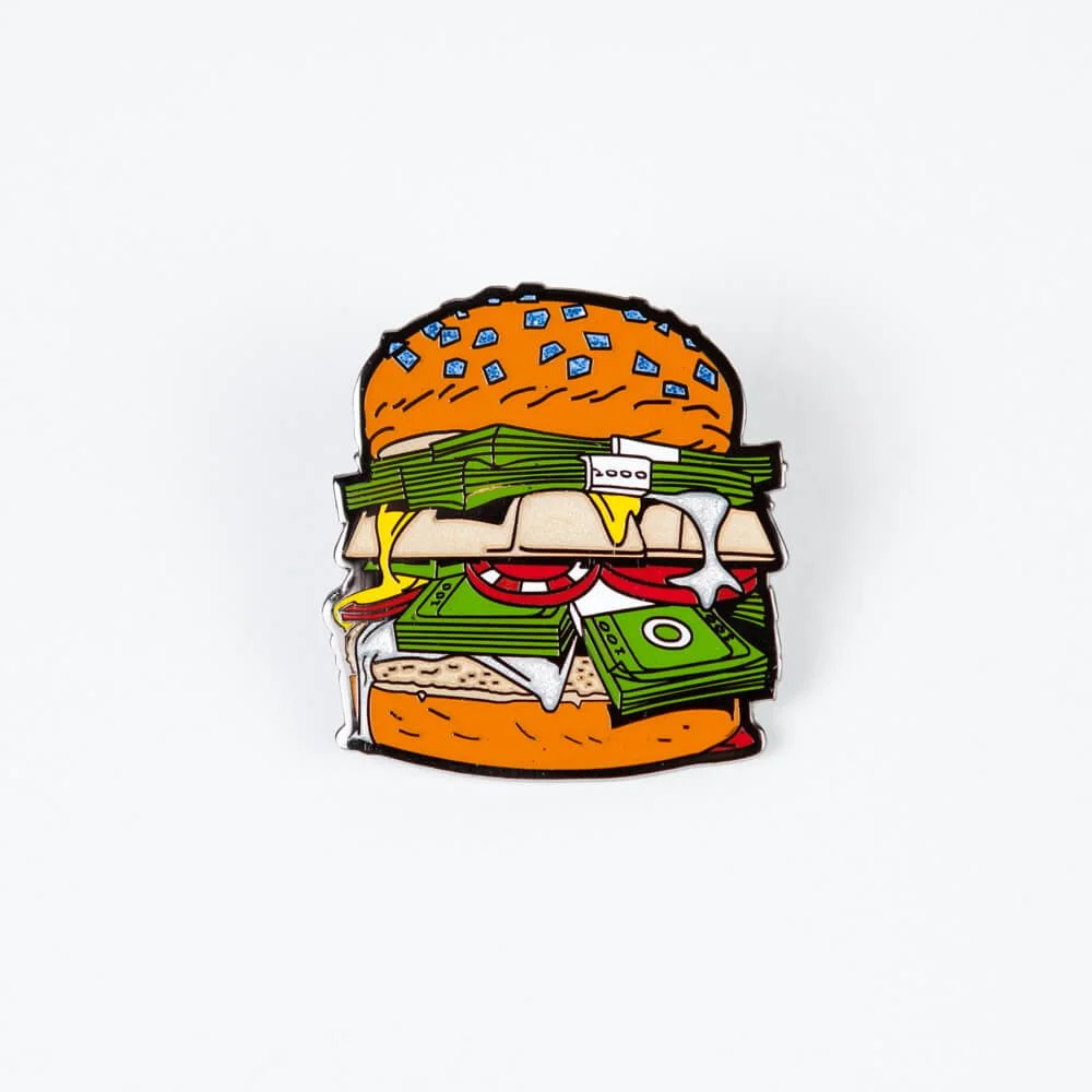 A hard enamel pin shaped like a stacked burger.