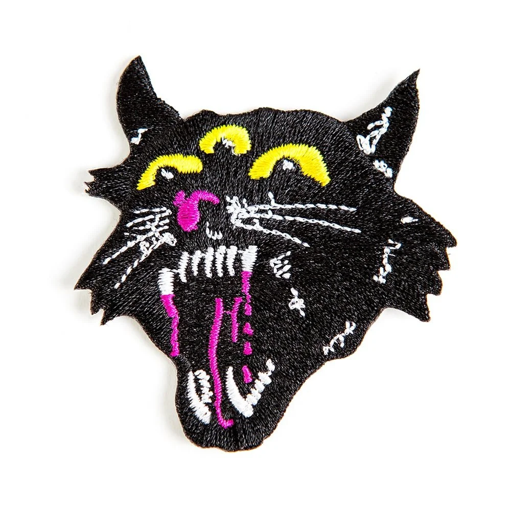 An embroidered patch cut to the shape of a black cat head.