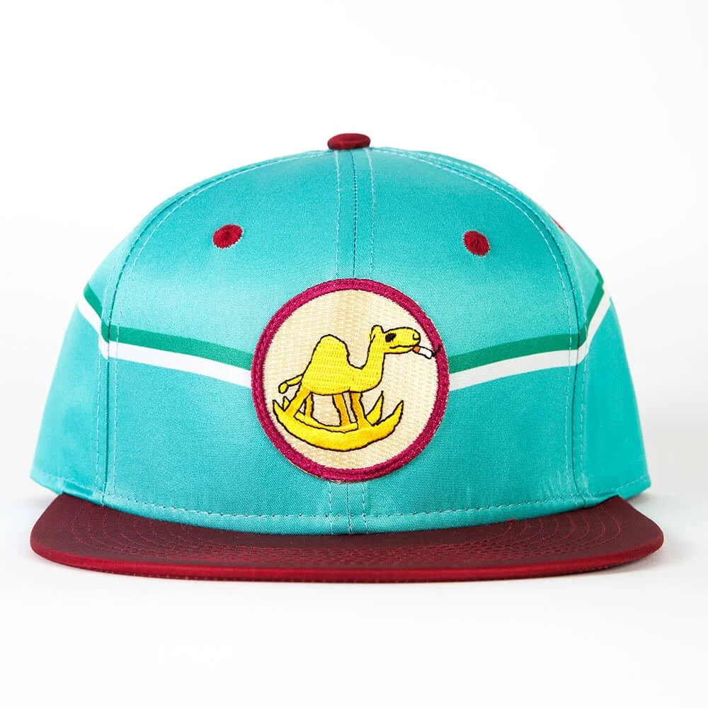 A turquoise and red snapback hat with a round embroidered patch of a camel.