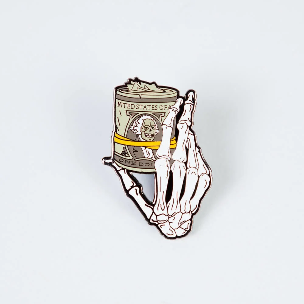 A hard enamel pin, a skeleton hand holding a tall can.