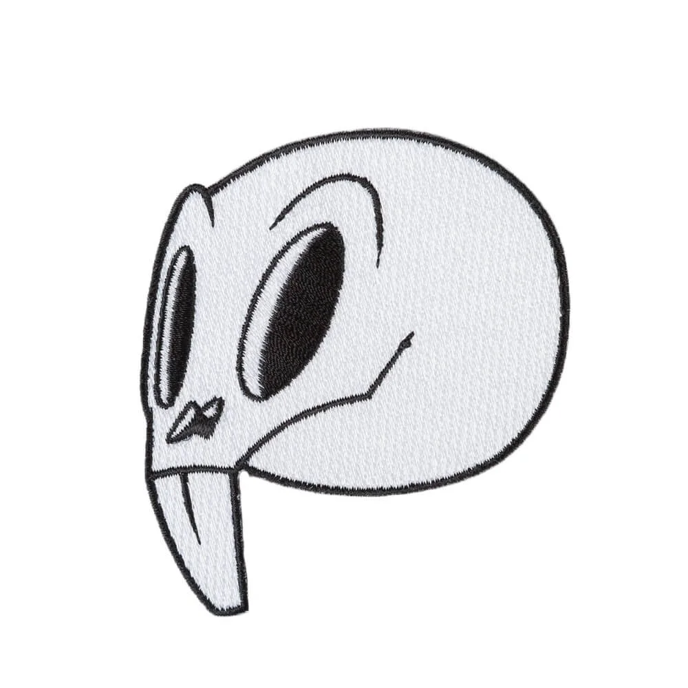 An embroidered patch cut to the shape of a pale alien head.